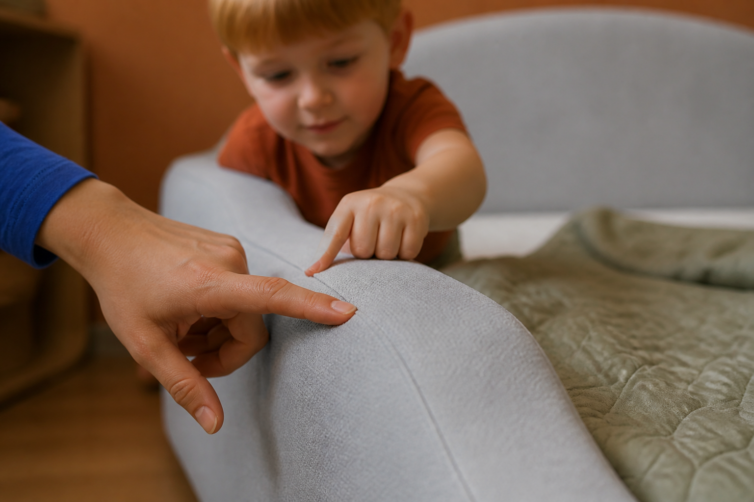 A parent and child feeling the soft padded side of the Little Lifely Bed.